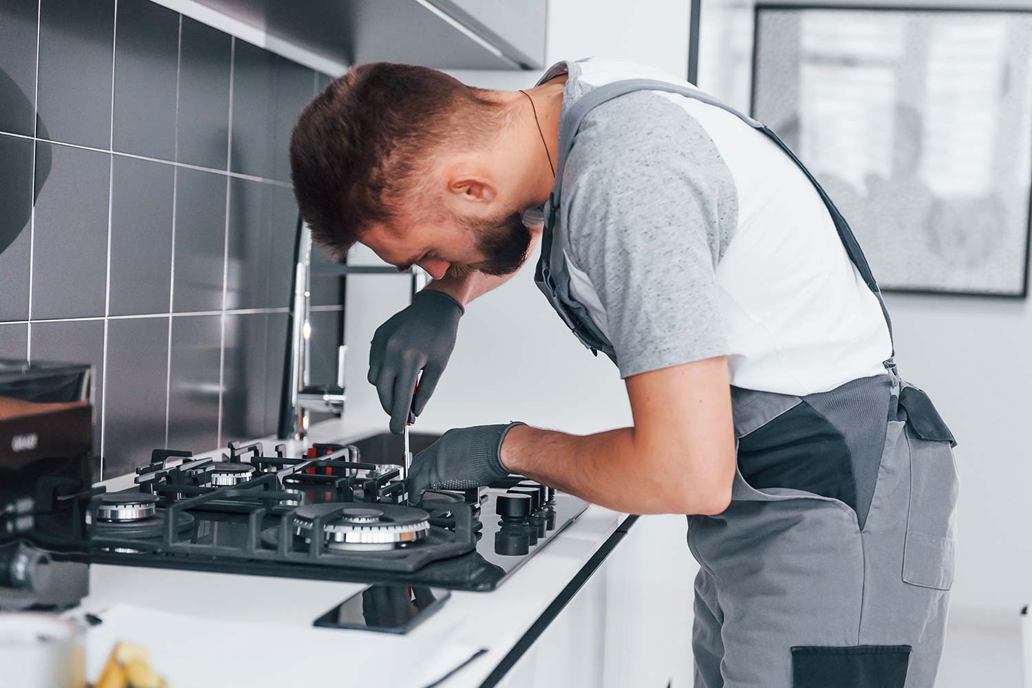 young-professional-plumber-in-grey-uniform-working-resize