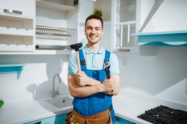 cheerful-male-plumber-holds-wrench-and-plunger-resize.jpg